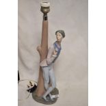 A Nao by Lladro lamp base of a Romeo style lover with rose leaning against a tree, 45cm tall.