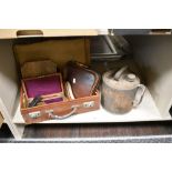 A vintage suitcase containing a lined geometry box, a wooden crumb tray and brush, a boxed