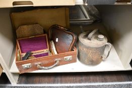 A vintage suitcase containing a lined geometry box, a wooden crumb tray and brush, a boxed