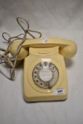 A vintage cream plastic Rotary phone.