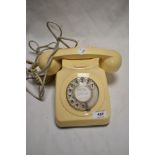 A vintage cream plastic Rotary phone.