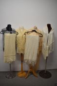 A collection of shawls, including two 1920s/30s rayon fringed shawls, crotcheted shawl and 1930s