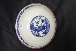 A 20th Century Chinese blue and white footed bowl, decorated with panels of figures and foliage,