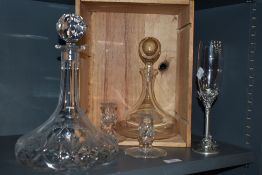 Two Edinburgh crystal candlesticks, a cut glass decanter, a plain decanter and two champagne