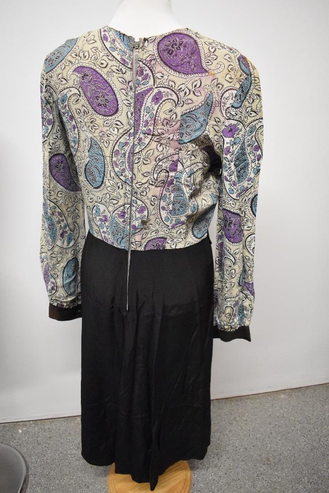 A 1940s dress, having paisley patterned bodice and black skirt, long sleeves and button details to - Image 6 of 6