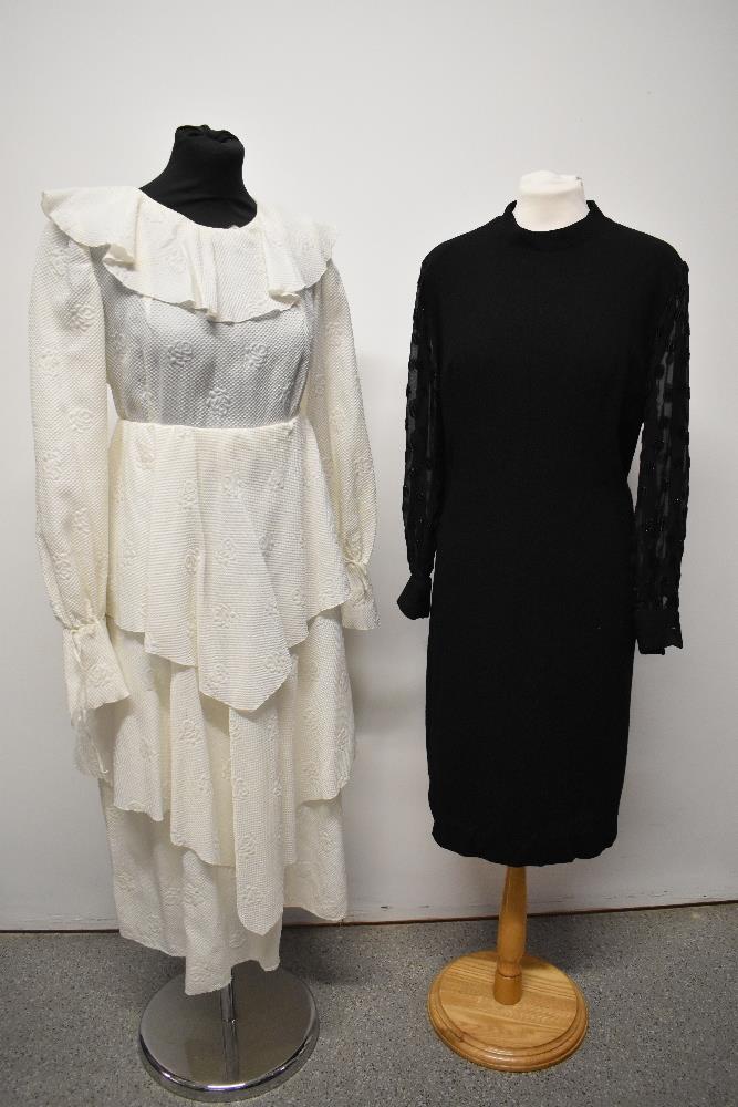 Two vintage dresses, comprising black wool crepe with sheer sleeves and white 1960s/70s with