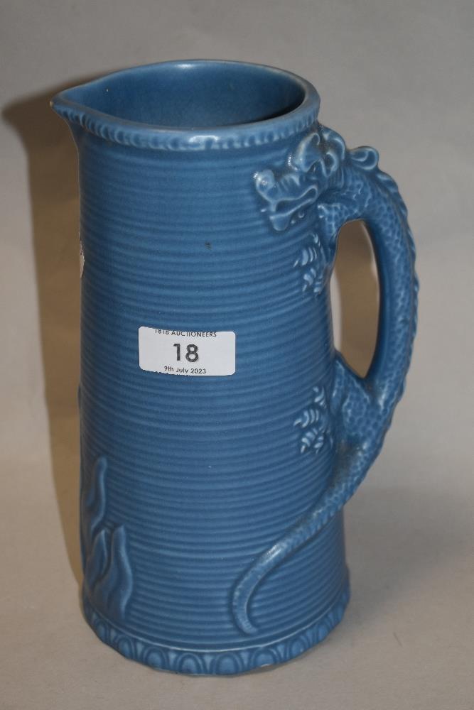 A mid century moulded jug, having blue glaze with dragon decoration to handle.