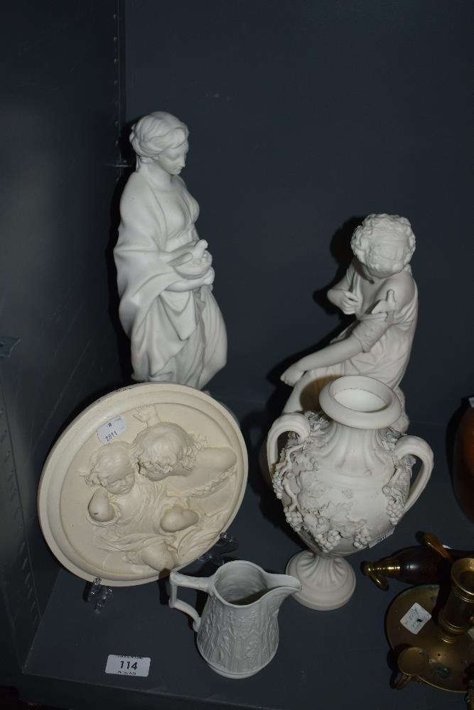 Two Parian Ware figurines, a similar handled vase with grape decoration, a Parian ware jug and a