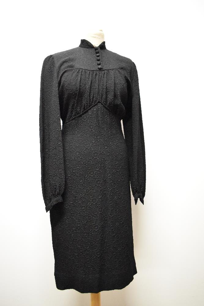 A 1930s/ 1940s textured day dress in black, having wide sleeves gathering into a fitted cuff,