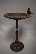 A novelty cast iron bird feeder & bird bath table, the circular top with pierced edge and ornamental
