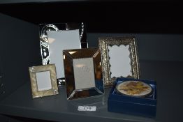 Four photo frames or varying style and size and a trinket dish with pressed flowers to lid.