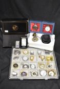 A tray of novelty and contemporary pocket watches and timepieces, some with enamelled decoration,