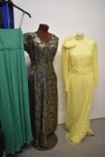 A selection of vintage dresses, including 1960s yellow bridesmaid dress with head dress.