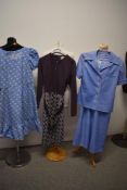 Three 1960s and 70s dresses, including blue dress with puff sleeves and heart pattern.