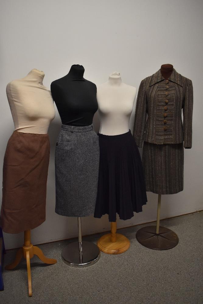 A vintage Windsmoor skirt suit and three skirts, including 1950s blue and grey herringbone and