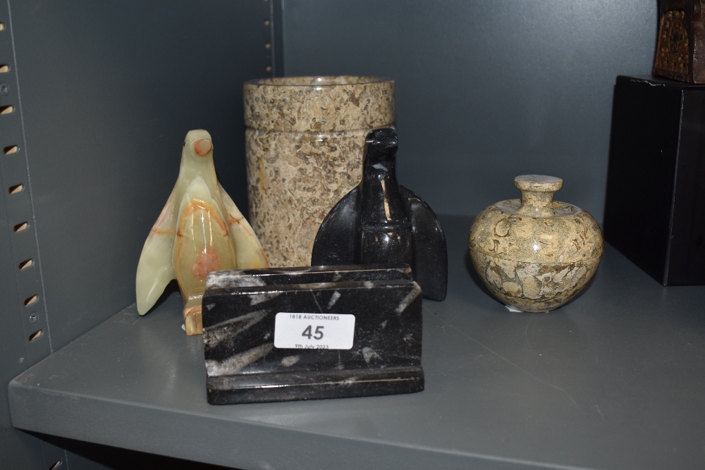 A selection of natural stone, onyx and black marble items, to include two penguins, letter rack,