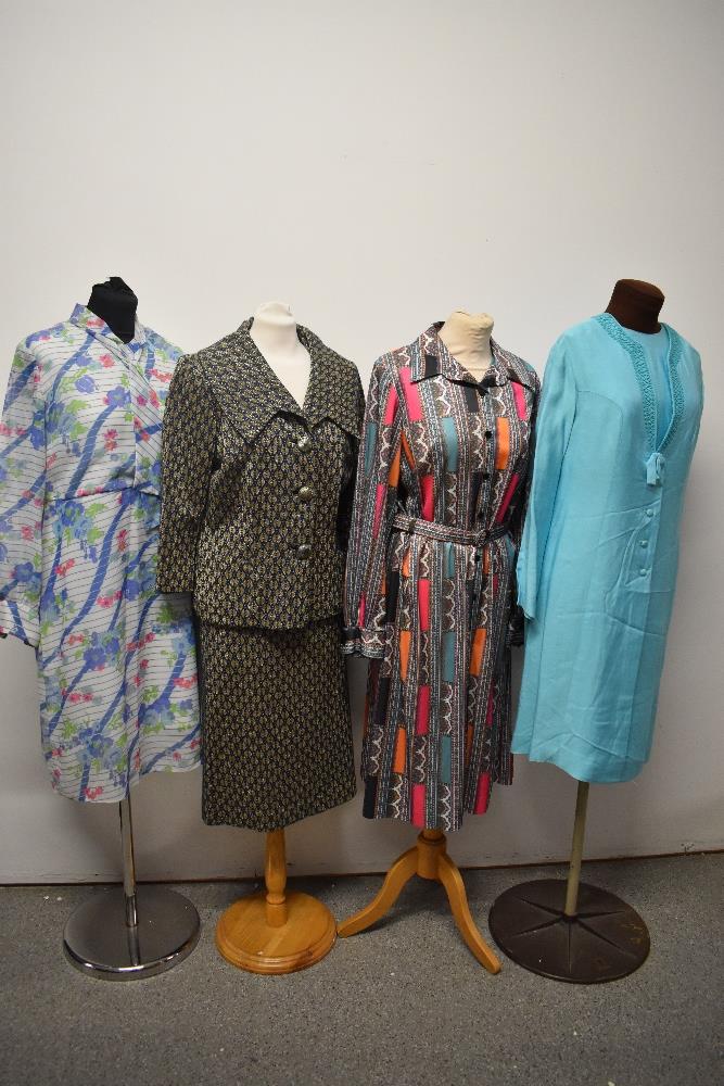 A mixed lot of vintage clothing, to include 1960s skirt suit, 1970s floral dress, 1970s paisley