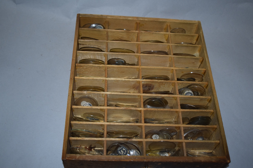 An early 20th century pine cabinet, housing a large collection of optometrists glass lenses. - Image 2 of 2