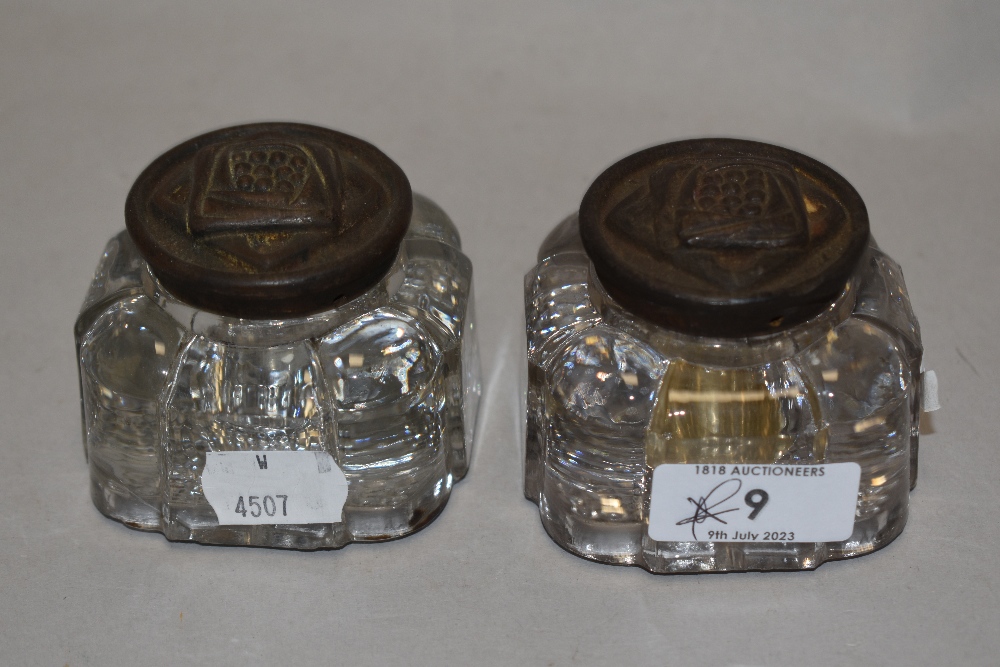 Two late 19th/ early 20th century pressed glass ink wells having embossed metal lids in the Rennie