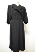 A 1940s textured day dress in black, faux cross over detail with buttons to front, 3/4 sleeves and