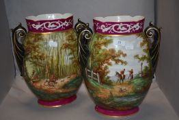 Two Edwardian twin handled vases, of ovoid form, having hand painted hunting scenes to cerise ground