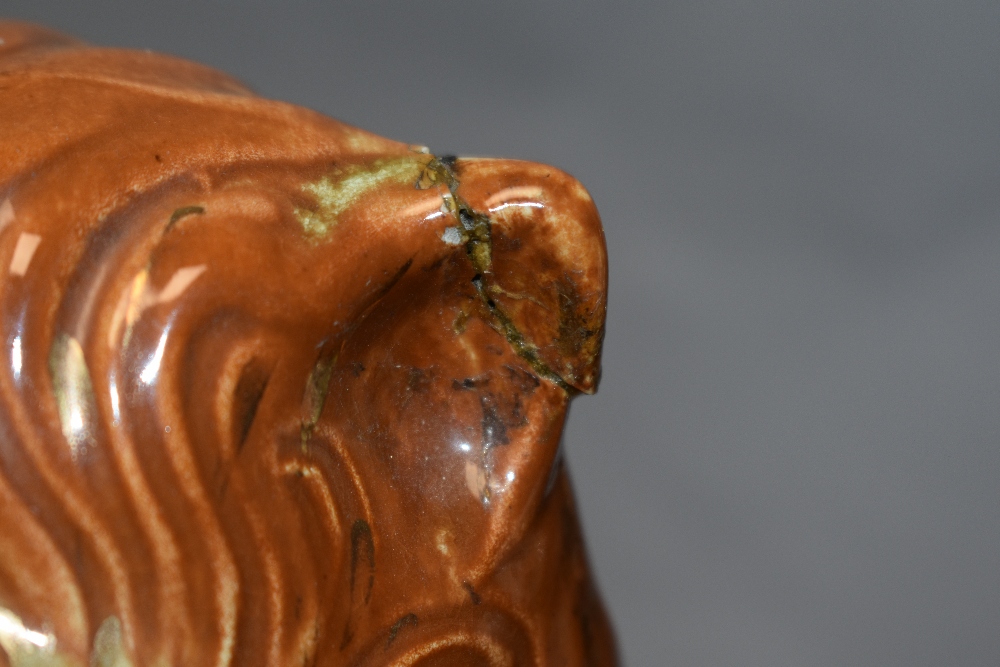 A pair of Victorian Staffordshire Pottery recumbent lion fireside ornaments, having applied glass - Image 2 of 3