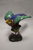 A 1920's Tuscan China Macaw/parrot ornament, modelled with expressionate pose and perched on a