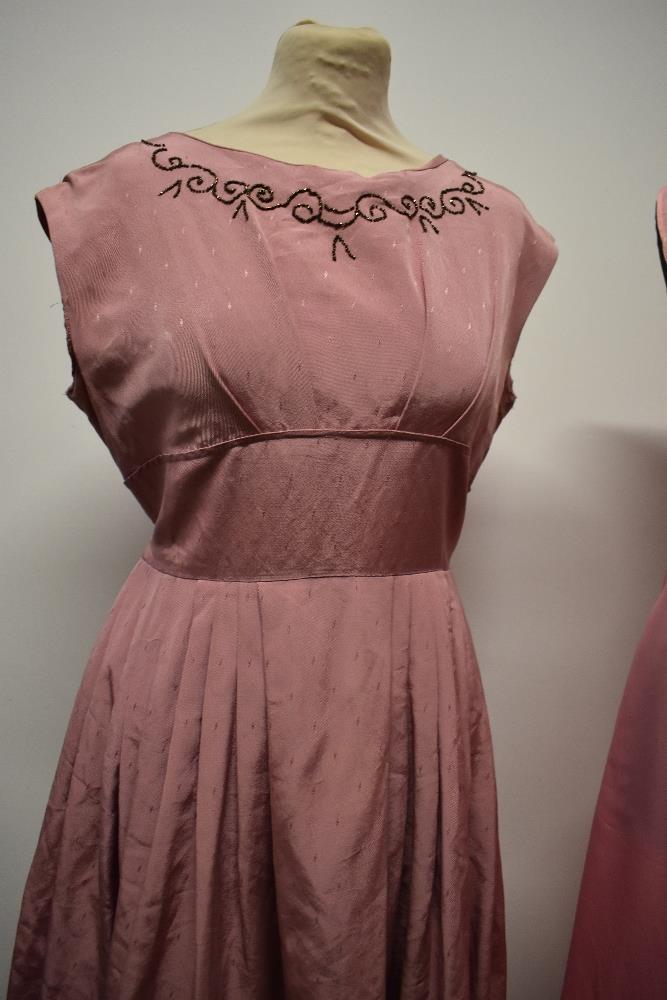 A 1950s grosgrain dress in rose pink, having full pleated skirt, beading to bust and half belt to - Image 5 of 8