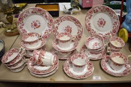 A Victorian porcelain part tea service on white ground and decorated with repeating floral motifs