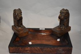 A carved wood tray or bowl and a pair of 1930s carved dog book ends.