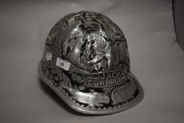 A moulded silver tone safety helmet, bearing designs of wild animals and the name Jack Cowbourne,