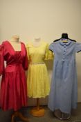 Three vintage dresses, including 1950s children's seersucker dress in blue, yellow American 1960s