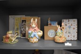 A collection of Beatrix Potter ceramics and books, including perpetual calendar, musical Peter