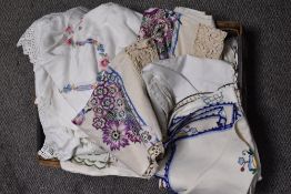 An assorted collection of 20th Century and other laced table cloths, place settings, and