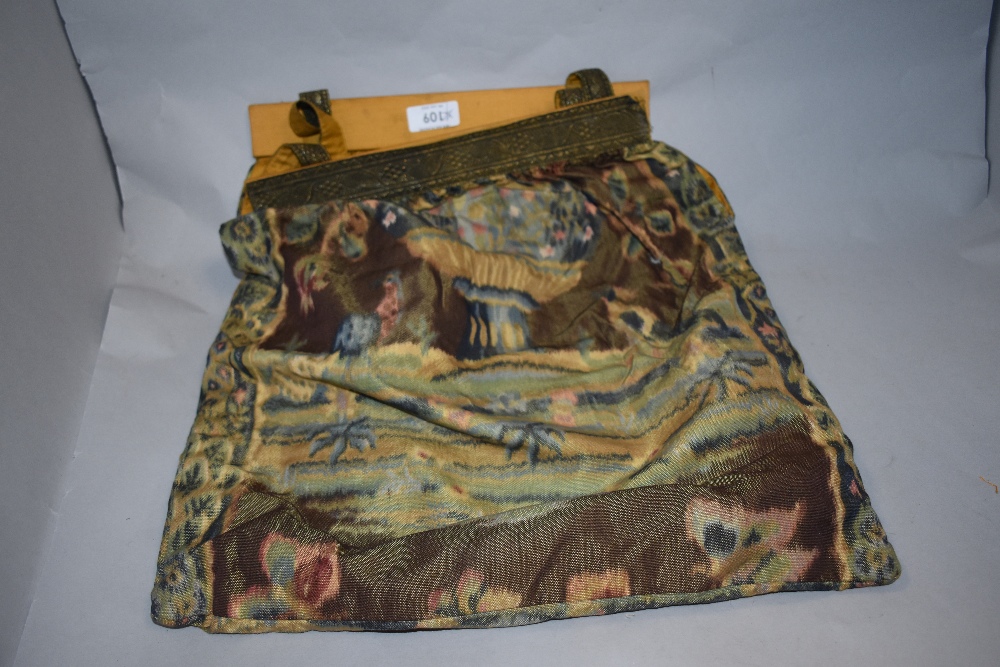 An early 20th century bag, having floral pattern and metallic thread to handles and frame.