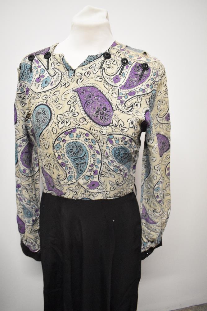 A 1940s dress, having paisley patterned bodice and black skirt, long sleeves and button details to - Image 2 of 6