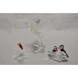 A group of three Swarovski crystal animal studies, comprising a perched eagle, toucan with