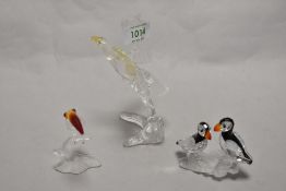 A group of three Swarovski crystal animal studies, comprising a perched eagle, toucan with