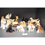A collection of small Beswick pottery dogs, Hounds seated 3375, Golden Retrievers seated 3383,