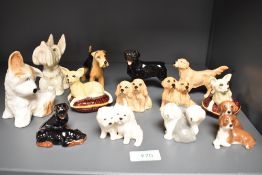 A collection of small Beswick pottery dogs, Hounds seated 3375, Golden Retrievers seated 3383,