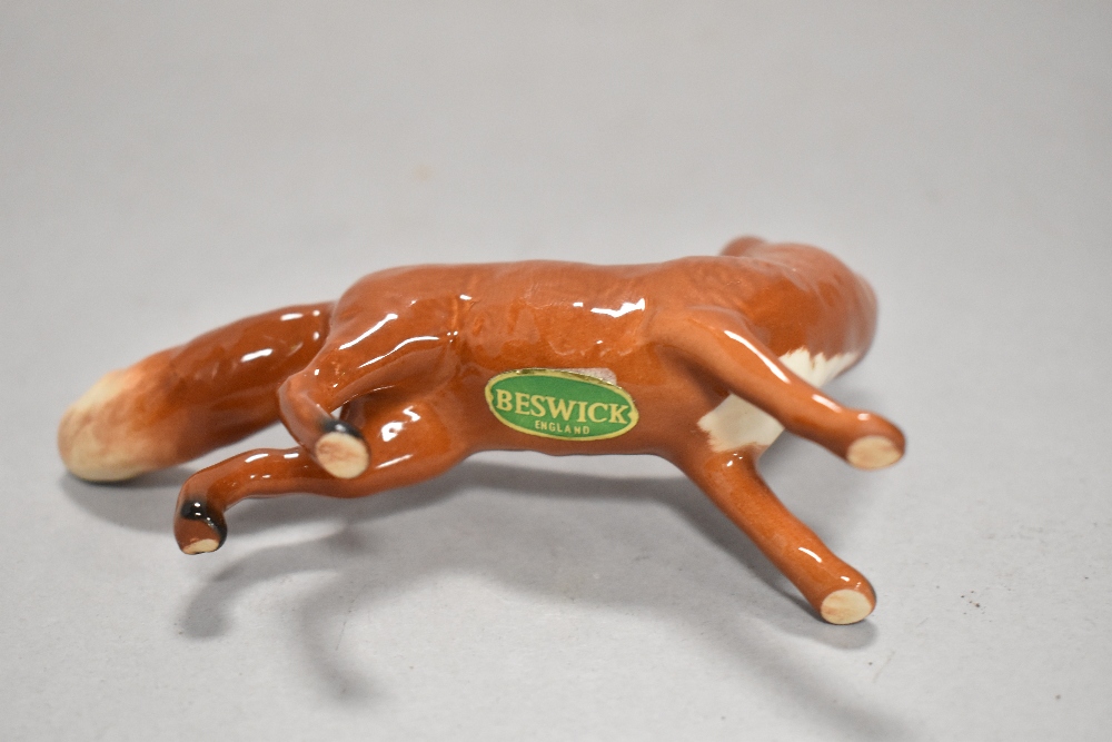 A Beswick pottery figure, The huntsman, four hounds in various poses and a fox. - Image 5 of 5