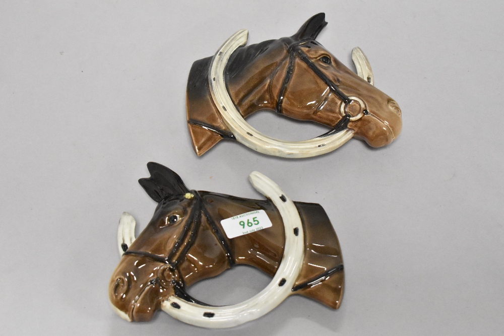 A pair of Beswick pottery horse head wall plaques, Looking through the horse shoe (806 and 807).