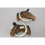 A pair of Beswick pottery horse head wall plaques, Looking through the horse shoe (806 and 807).