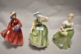 A group of three Royal Doulton porcelain figurines, comprising Lilac Time HN2137, Clarissa HN2345