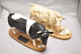 A Connoisseur Beswick Pottery Charolais cow and calf on plinth A2648 and Friesian bull on plinth
