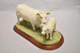 A Border Fine Arts 'Cattle Breeds' Charolais Cow & Calf group, c2002, model number A1249, on moulded