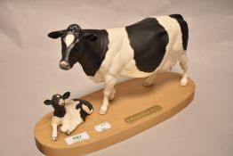 A Connoisseur Beswick Pottery Friesian cow and calf on plinth A2607/2690, in matte finish.