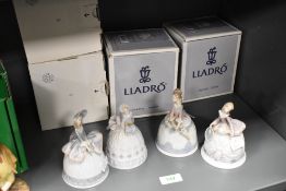 Four Lladro bells in the form of crinoline ladies, with boxes, 05954, 05956, 05953 and 05955.