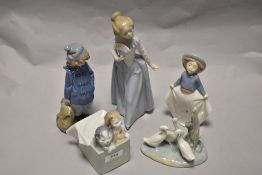 A group of Nao Figures and studies, including Girl with fan and kittens in gift box.