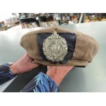 A WWII Tam O Shanter Cap to the Argyll and Sutherland Highlander Badge with Tartan backing, dated